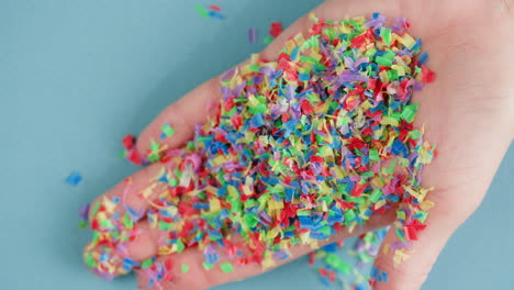 colorful plastic confetti in hand