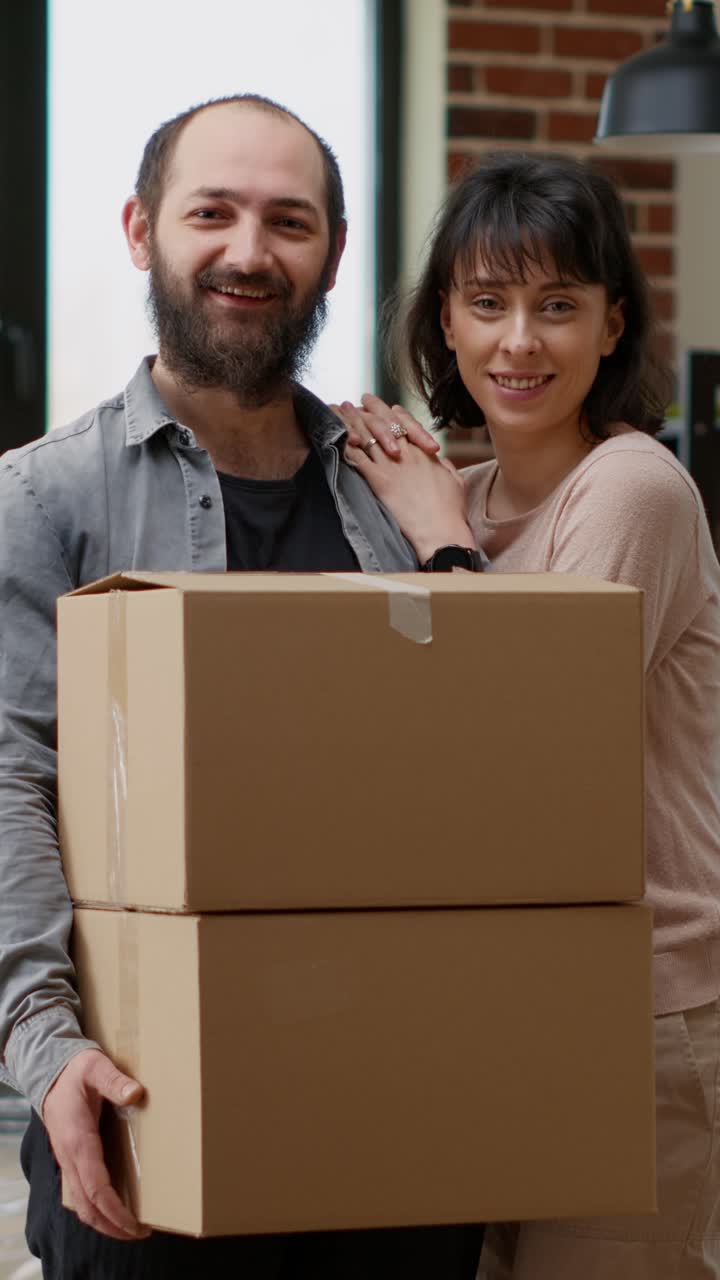 Couple moving into a new home with cardboard boxes