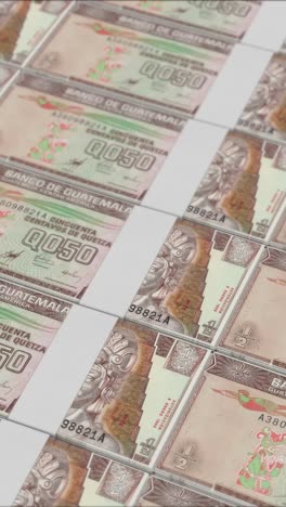 vertical video of half guatemalan quetzal banknotes printed by a money press