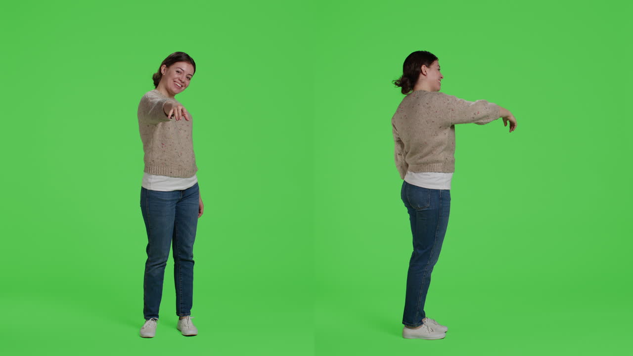 Woman in casual clothes pointing on green screen