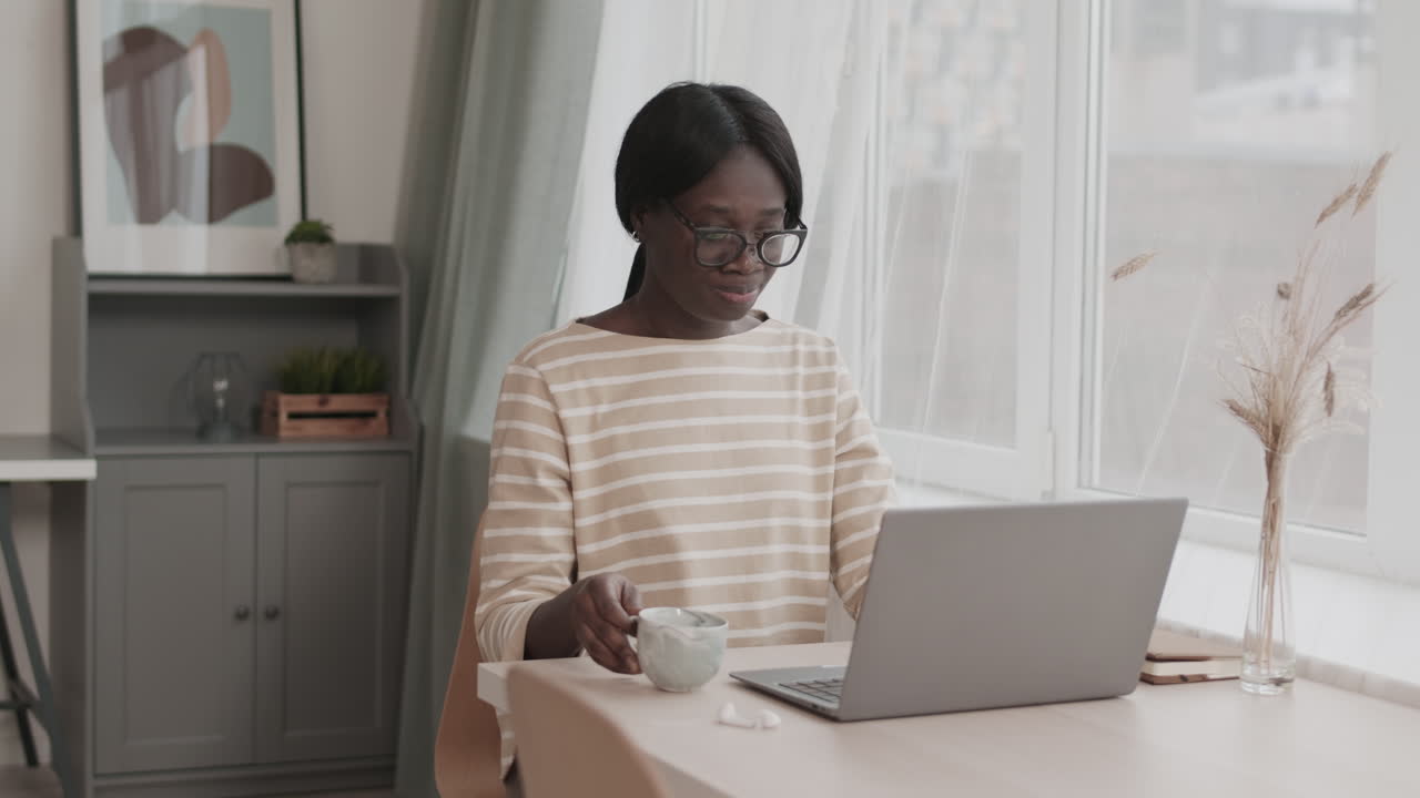 Female Freelancer Working from Home and Drinking Coffee