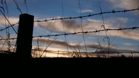 timelapse blue skies with clouds passing over farmland as sun is setting