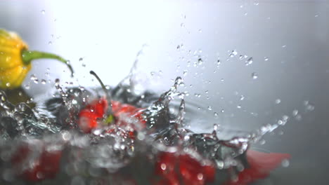 chili peppers falling in water