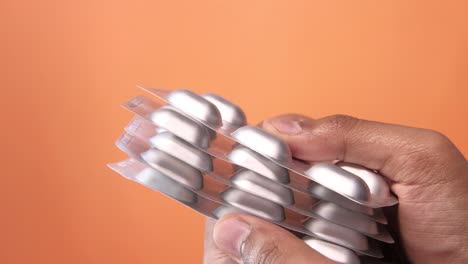 hand holding a blister pack of pills