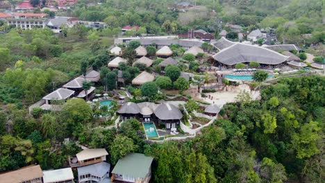 luxury villa resort with pools in bali island, aerial orbit view