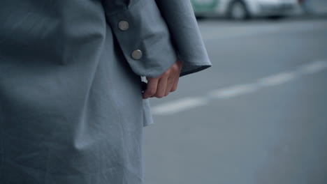 Female-hand-city-road-on-daytime.-Woman-crossing-street-in-downtown.