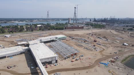 Customs-plaza-and-Gordie-Howe-bridge-under-construction,-aerial-drone-view