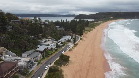 drone ascending over a peninsula revealing expensive home on the hill and a bay on the other side of the peninsula