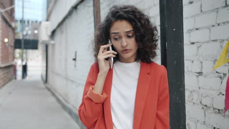 woman on a phone call in an alley