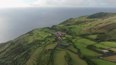 aerial view of small town mosteiro in green scenery at flores azores