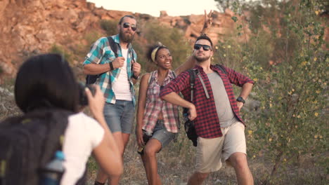 group of friends taking photos on a hike