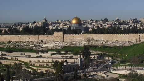 focus pull and pan right to wide view of jerusalem's temple mount. cars are seen active on roads in this vast landscape.