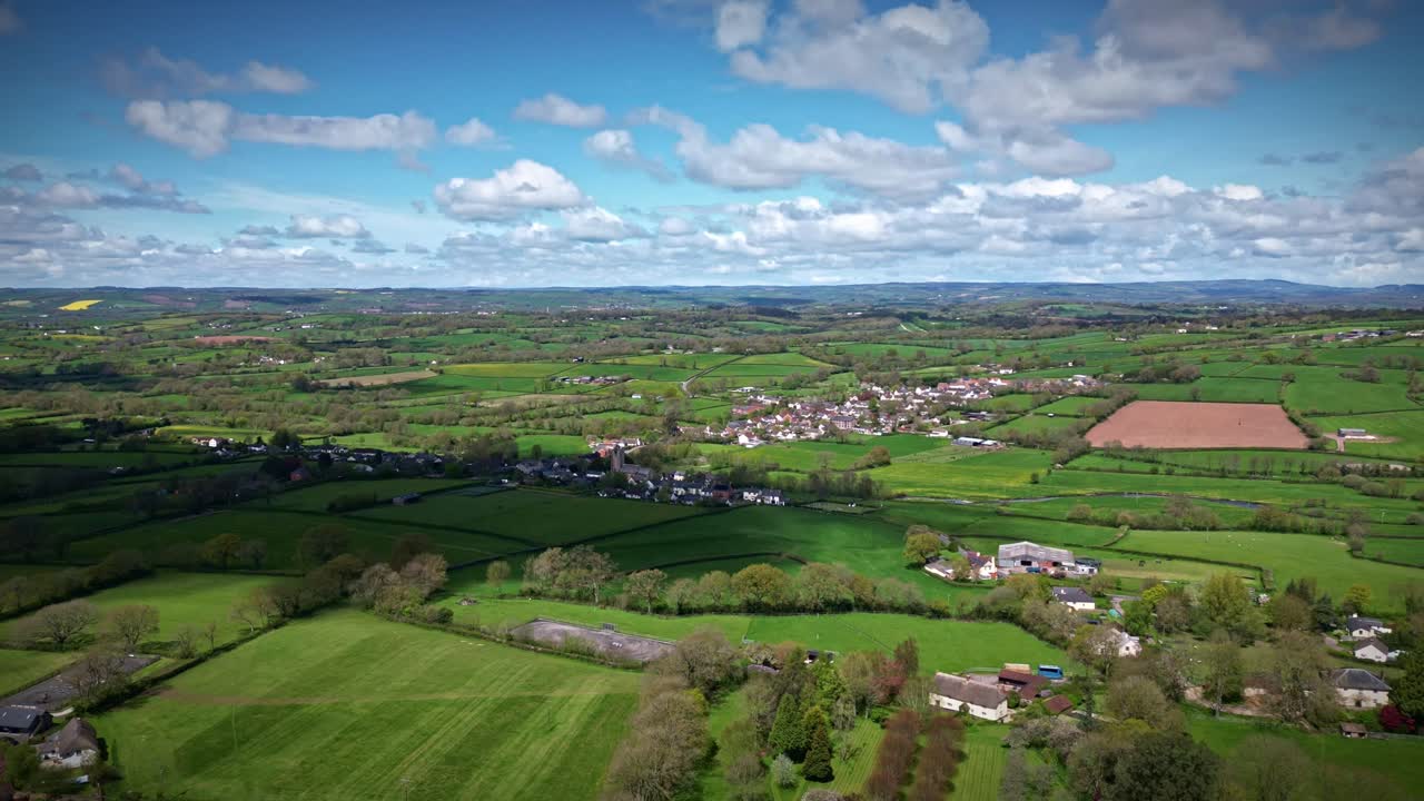 Straight ahead drone filght hyperlapse, timelapse of Culmstock, a village on the Devon Somerset border on the edge of the Blackdown Hills in England with clouds casting shadow on the ground
