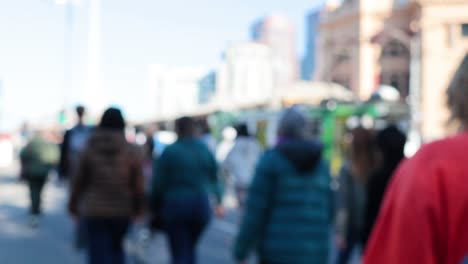 people walking near a train station in melbourne