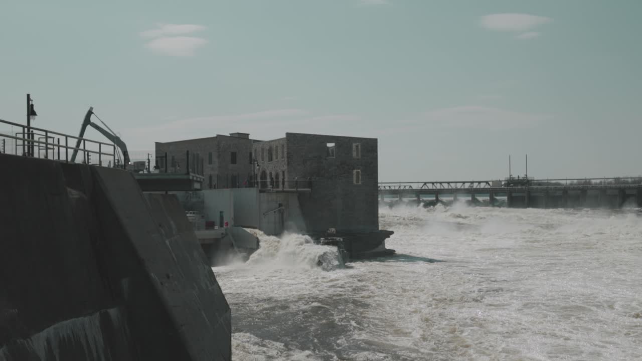 Water raging through a old Hydro electric power station and levee on the Ottawa RIver during flood season on Chaudière Island
