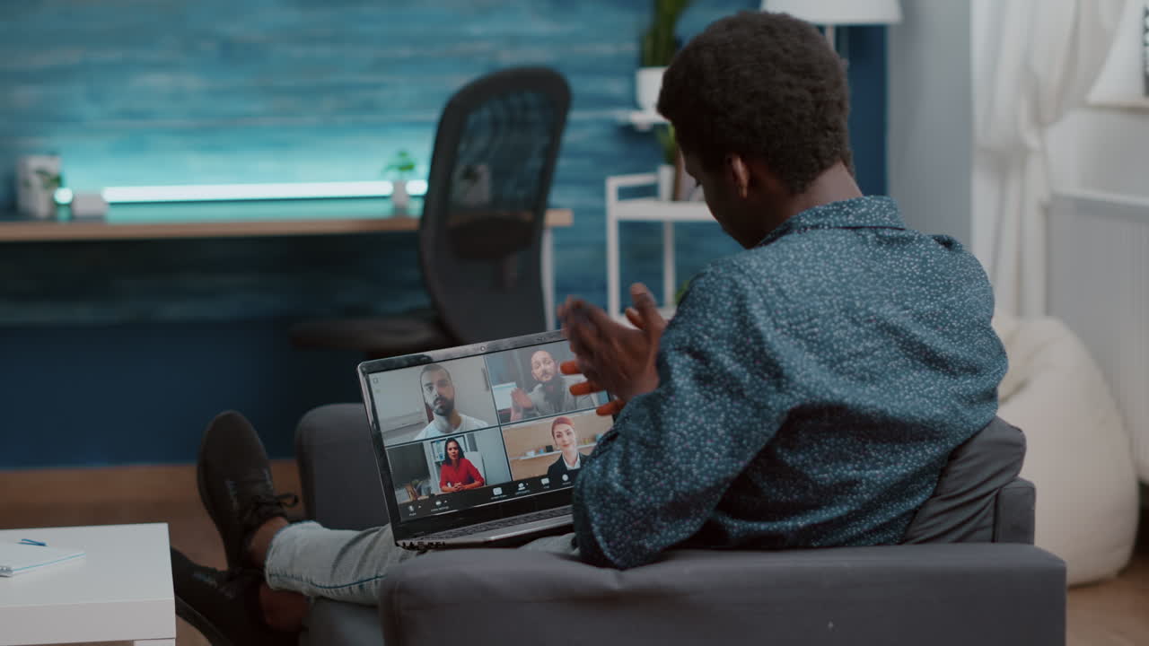 African american man unsing laptop for online internet conference chat with his coworkers