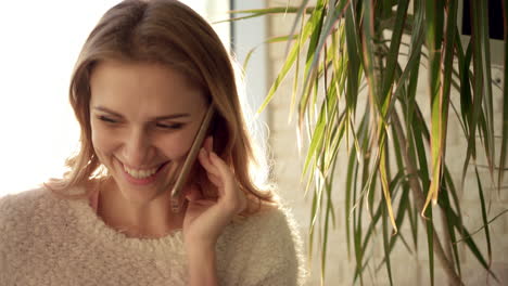 smiling woman talking on phone