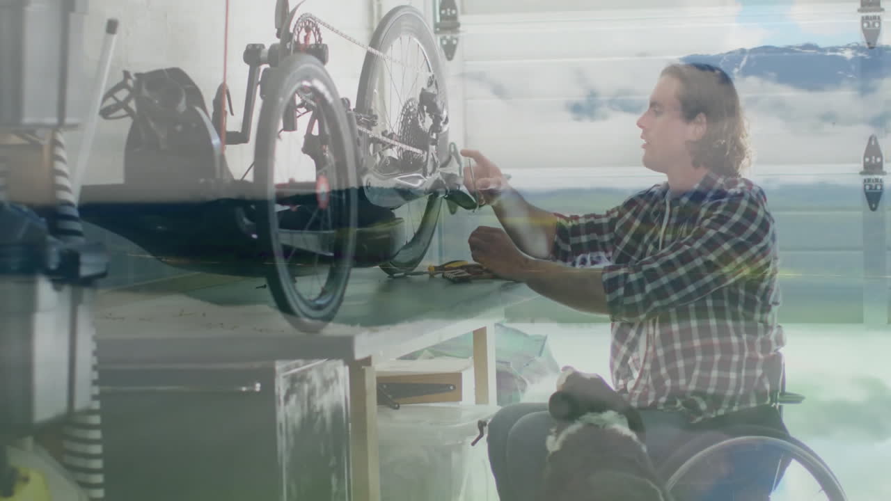 Repairing bicycle in garage, person in wheelchair with dog nearby