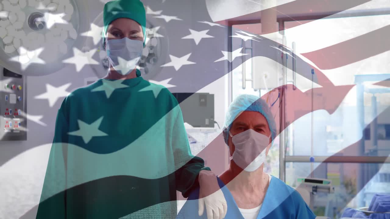 Telecamera che si muove verso l'alto rivelando un team medico tra i monitor, che assume una posa di supporto sotto una sovrapposizione di bandiera.