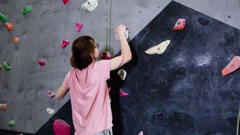 teenage boy climbing indoors