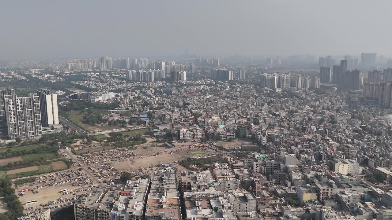 Aerial shot revealing Noida’s dense housing blocks, tall skyscrapers, and smoothly flowing traffic corridors across the city