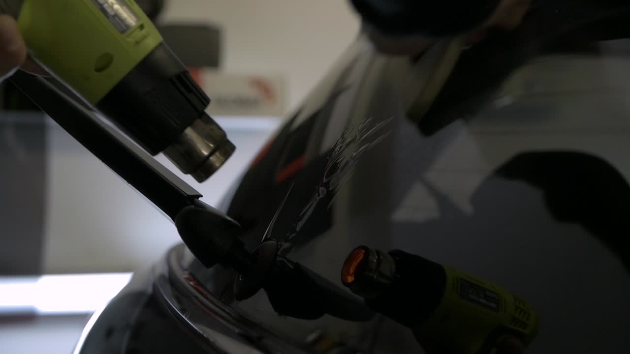 Car Window Tinting pushing air bubbles out from under the foil