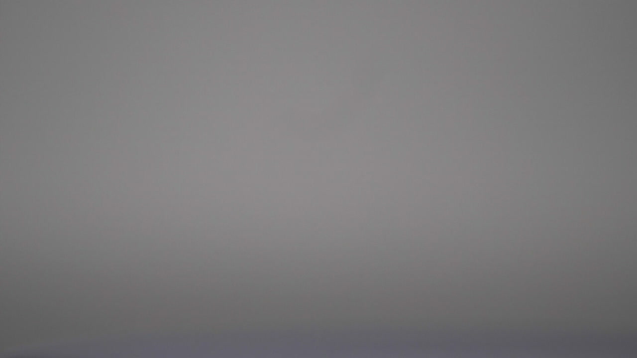 Dripping thick blue liquid in grey background - close up