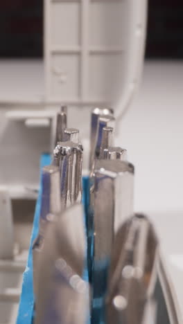 set of different shaped metal heads for screwdriver in open box on table macro view zoom out. manual tools kit. professional handyman supplies