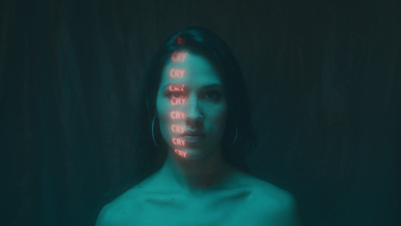 Woman with Neon 'CRY' Projection