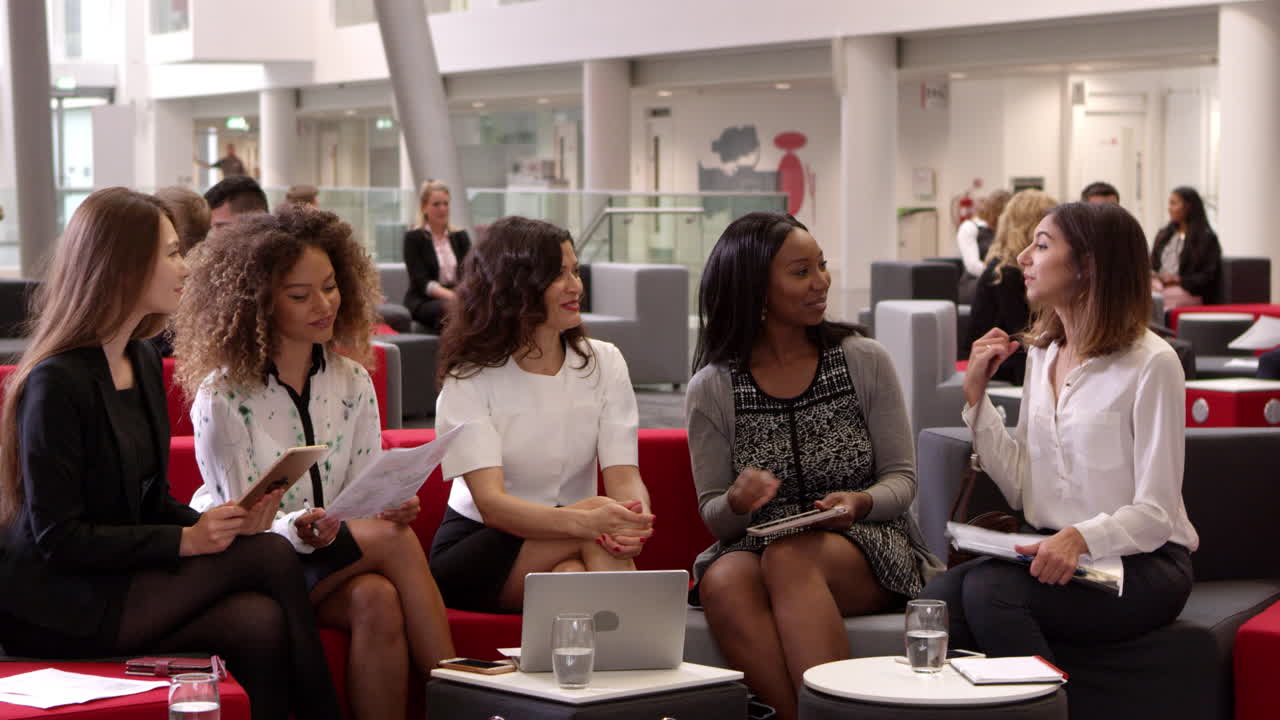 Businesswomen Meeting In Lobby Of Modern Office Shot On R3D