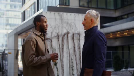 two men talking outdoors