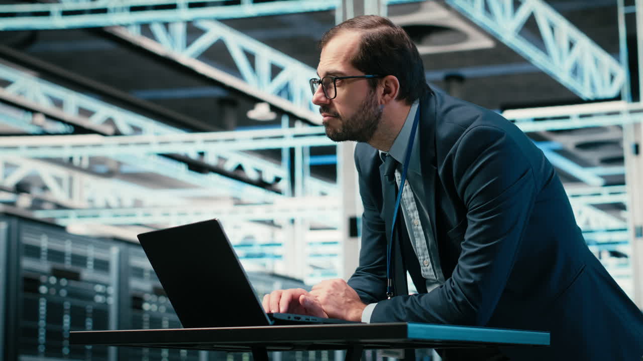 IT Professional Working on Laptop in Data Center