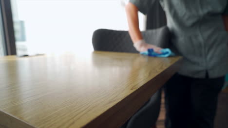 the maid efficiently goes about her tasks, tidying up the hotel room with precision and care, by wiping and cleaning everything in a hotel room