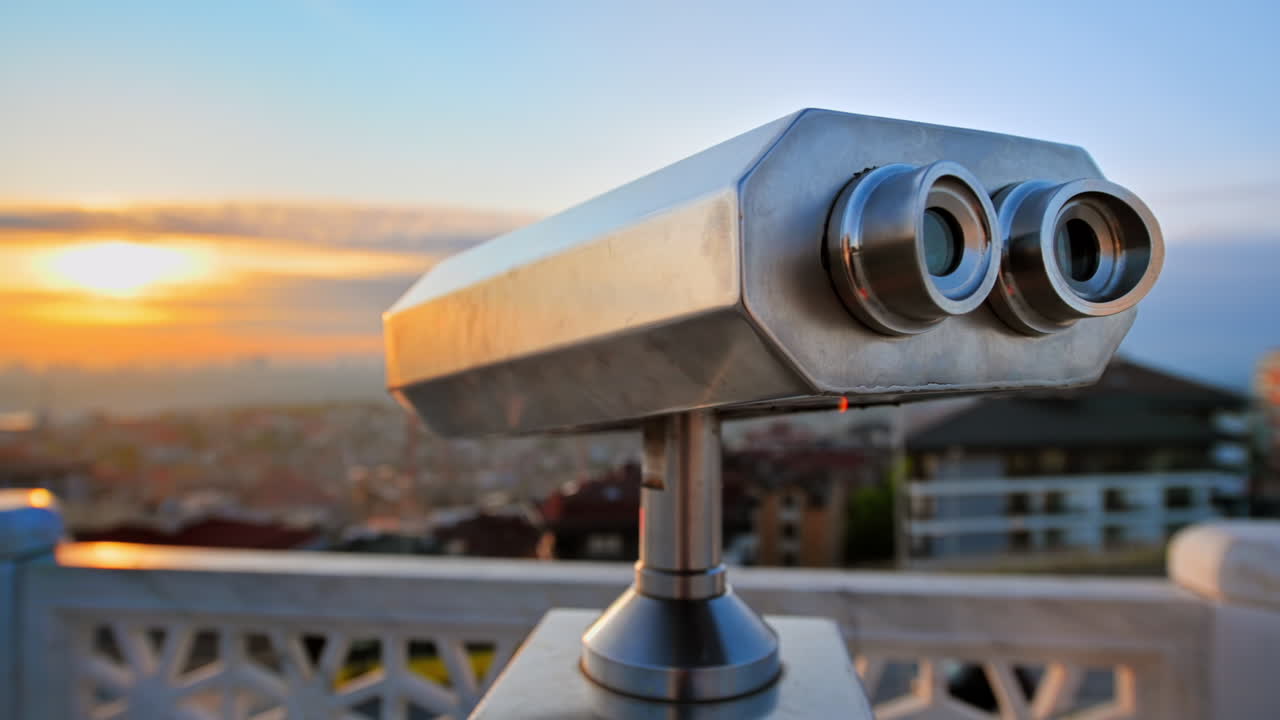 Binoculars on a viewpoint located in Balat district in Istanbul, Turkey. Sunset and downtown on the background