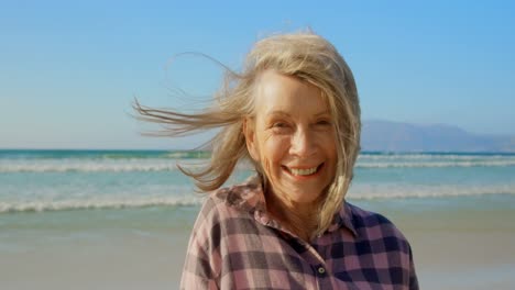 Front-view-of-active-senior-Caucasian-woman-standing-on-the-beach-4k