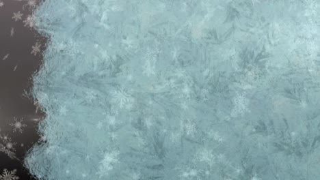 Digital-animation-of-background-freezing-against-snowflakes-falling-against-grey-background