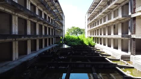 Aerial-tracking-shot-of-an-abandoned-and-overrun-hotel-resort-in-Bali