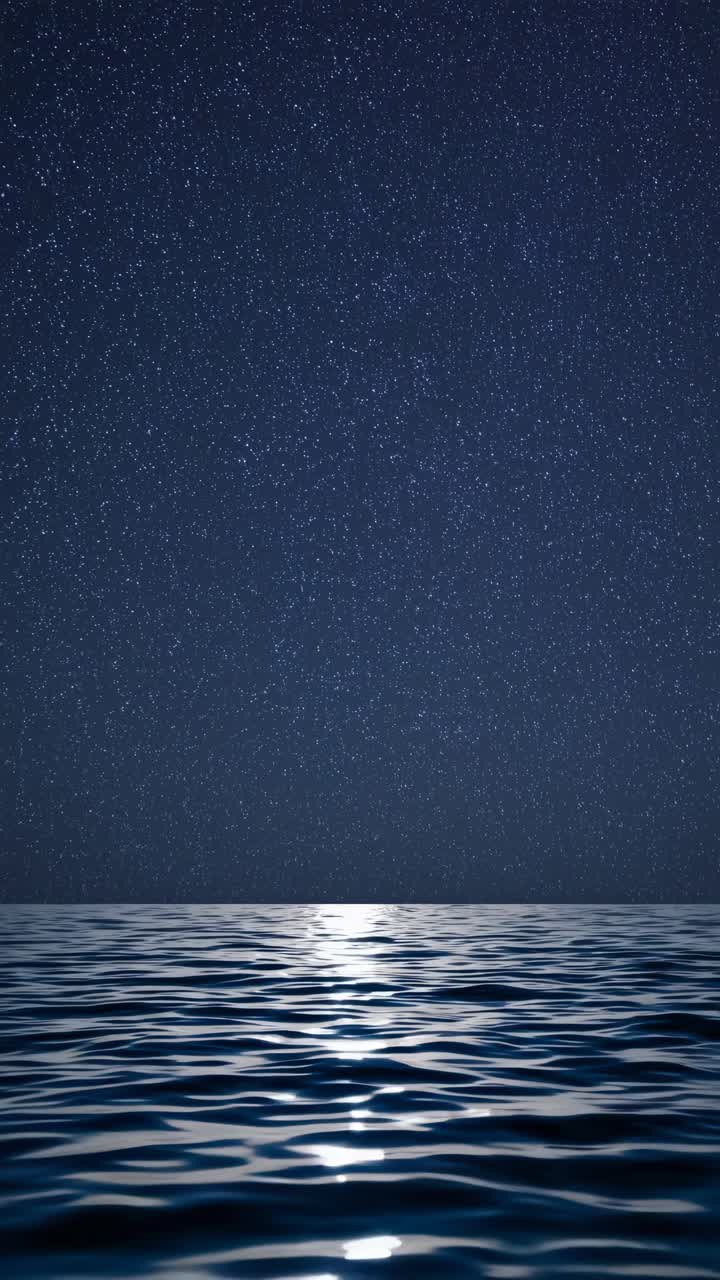 A serene night sky video with a low-angle view over calm ocean waters, reflecting starlight