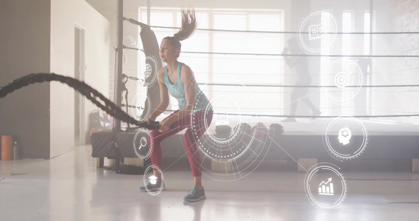 Vertical video: Woman grabbing ropes and making alternating waves, HUD floating around for fitness
