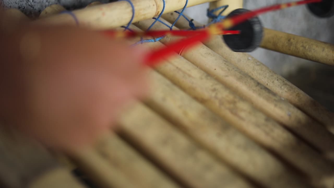 Slow Motion handheld shot of someone playing an Indonesian Xylophone
