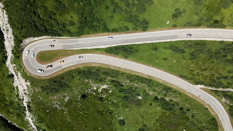 static aerial zenital view of the road with many cars in grimselpass, switzerland