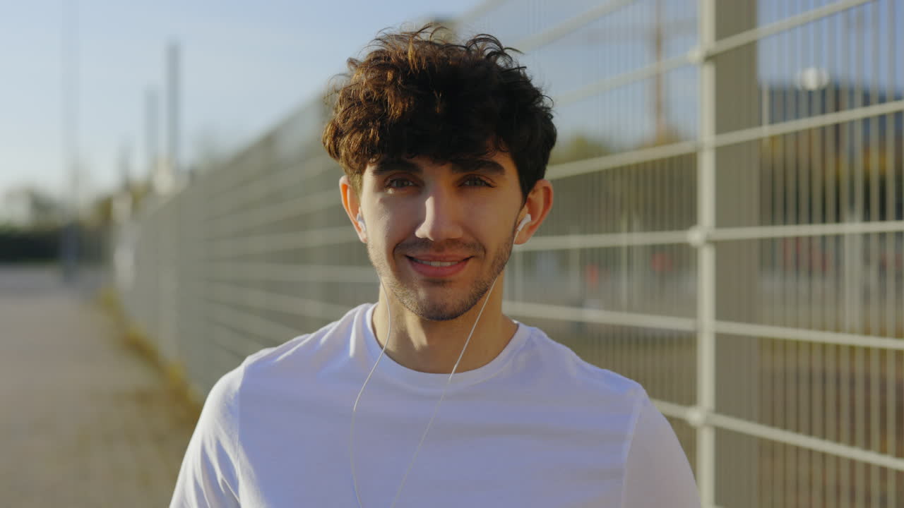 Smiling Man with Earbuds