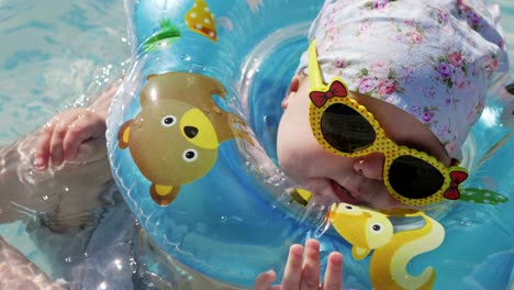 baby swimming with neck swim ring