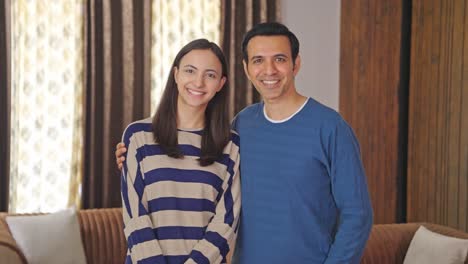 Happy-Indian-couple-smiling-towards-the-camera