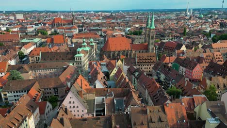 4k aerial drone video of the copper-clad twin spiers on the beautiful st. sebald church in downtown nurnberg, germany