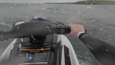 POV-shot-of-a-jet-skier-racing-across-the-choppy-waves-getting-airtime