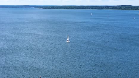 lonely sailboat in vast lake in poland, aerial drone view