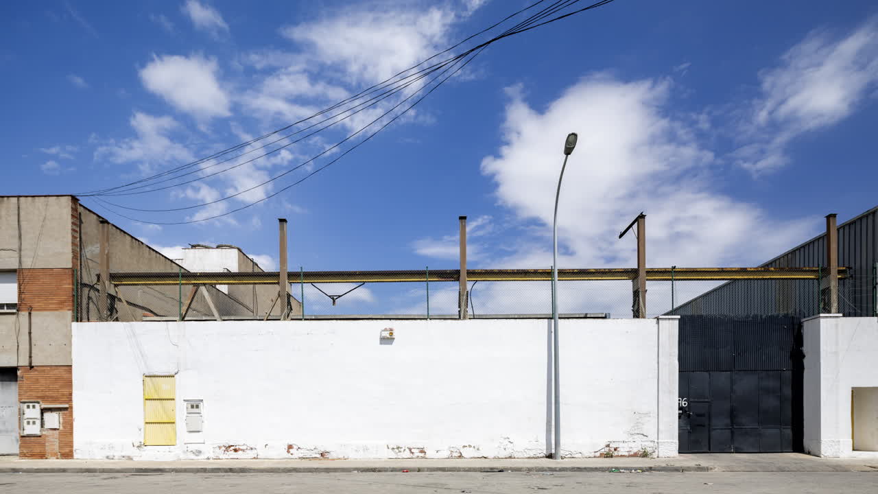 Old factory and industrial complex with passing clouds