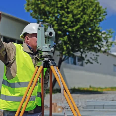 construction engineer supervising work at building site