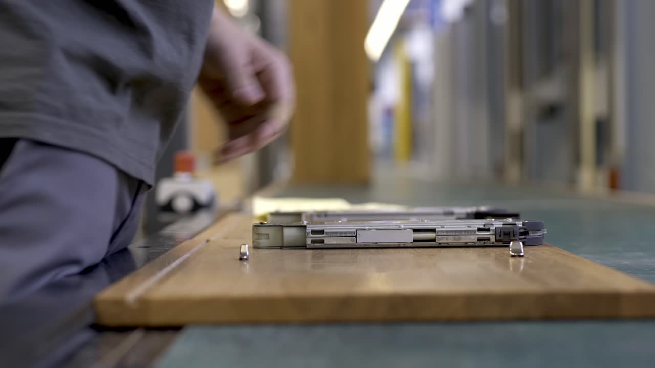 Medium shot of worker assembling cabinet parts.